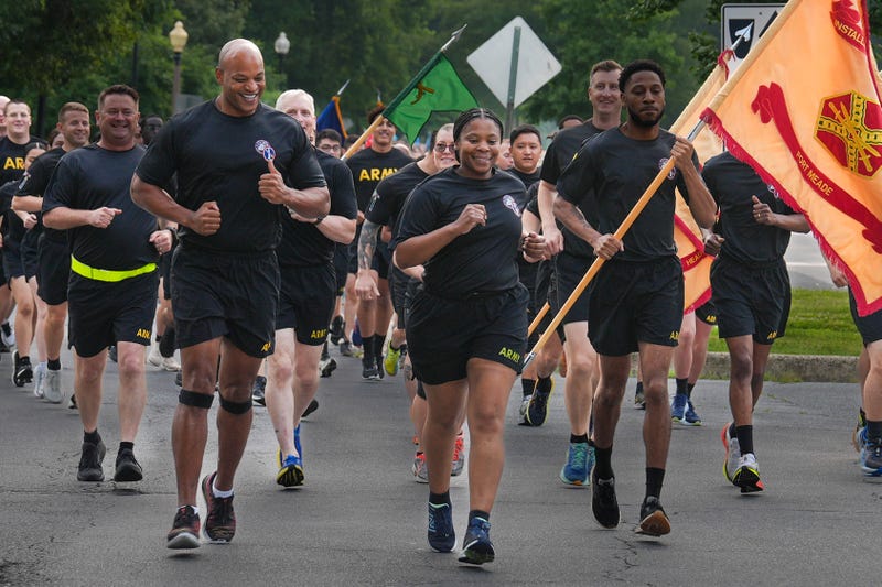 Maryland Governor and Army veteran Wes Moore runs with Fort George G. Meade Garrison Commander Col. Yolanda Gore