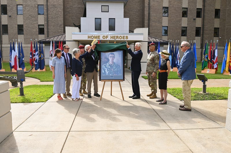 Members of the Polk family unveil a portrait of the general at the redesignation ceremony held July 11 at Fort Polk in front of Woodvill Hall