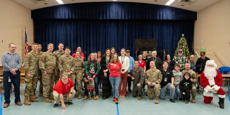Volunteers from the 128th Air Refueling Wing, Wisconsin Air National Guard, pose for a group photo before distributing gifts to veterans at the Clement J. Zablocki VA Medical Center in Milwaukee, Wis., Dec. 22, 2025.