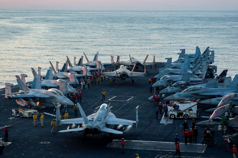 U.S. Sailors taxi aircraft to a staging point on the flight deck of Nimitz-class aircraft carrier USS Abraham Lincoln (CVN 72) in support of Operation Epic Fury, Feb. 28, 2026.