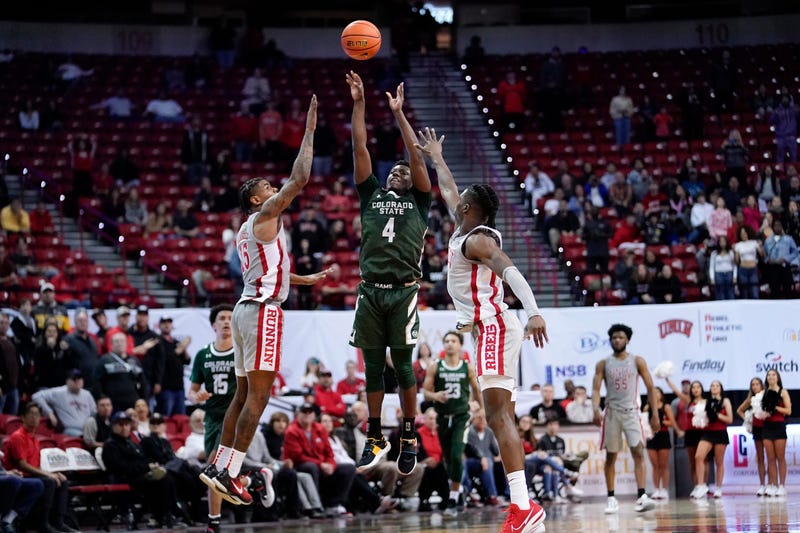 Colorado State Rams guard Isaiah Stevens (4) scores a three-point shot against UNLV Runnin Rebels guard Luis Rodriguez (15) and forward Victor Iwuakor (0) and brings the game into overtime at Thomas & Mack Center.