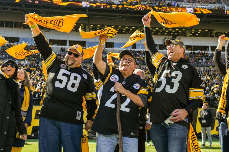 Jim Zimmerman Sr. (center) and Bill Soloway (right) lead the Pittsburgh faithful in waving their Terrible Towels.