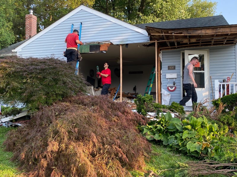 Restoration work begins on a house in Mount Holly, New Jersey after an ambulance crashed through its wall and window on July 3, 2025.