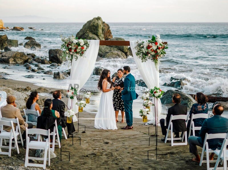 This photo shows bride Namisha Balagopal and groom Suhaas Prasad getting married in a small legal ceremony Aug. 15, 2020, on Muir Beach near San Francisco. 