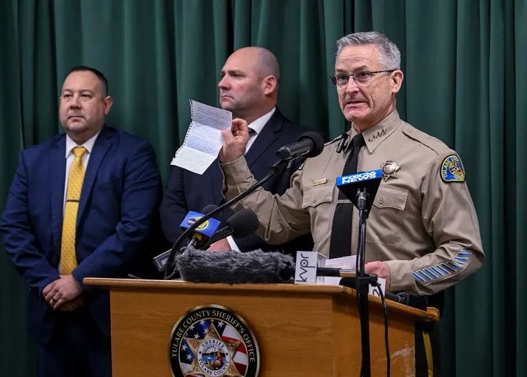 Tulare County Sheriff Mike Boudreaux holds a letter Monday, Jan. 30, 2023, from a Maine woman that sent $100 to add to the reward offered for information about a mass shooting that occurred January 16, in Goshen, Calif. No arrests were announced but autopsies confirmed that all six victims died from gunshot wounds. 