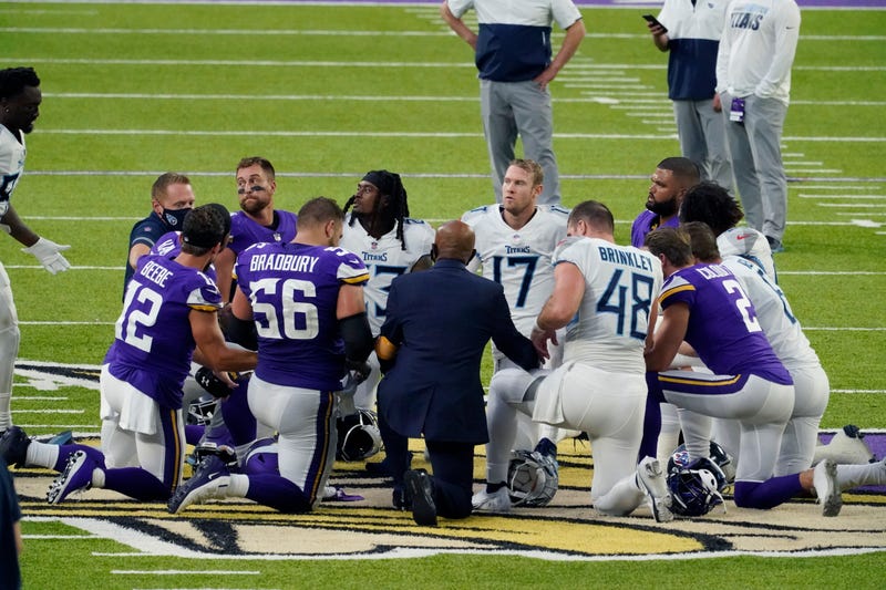 In this Sept. 27, 2020, file photo, Tennessee Titans and the Minnesota Vikings players meet at midfield following an NFL football game in Minneapolis.