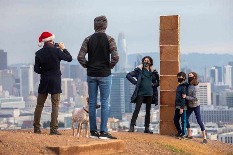A gingerbread monolith stands on Christmas Day, Dec. 25, 2020, on a bluff in Corona Heights Park overlooking San Francisco. A nearly 7-foot-tall monolith made of gingerbread mysteriously appeared on the San Francisco hilltop on Christmas Day and collapsed the next day. The three-sided tower, held together by icing and decorated with a few gumdrops, delighted the city when word spread about its existence.