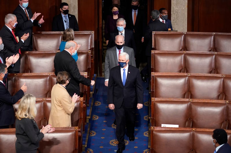 Vice President Mike Pence arrives with members of the Senate to officiate as a joint session of the House and Senate convenes to count the electoral votes cast in November's election, at the Capitol, Wednesday, Jan 6, 2021.