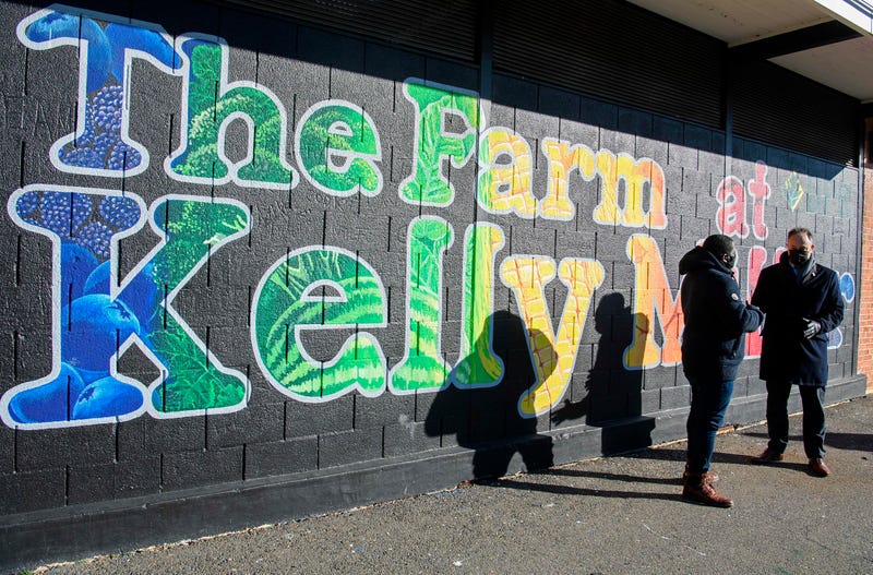 Second gentleman Doug Emhoff, the spouse of Vice President Kamala Harris, right, speaks with Christopher Bradshaw, executive director of Dreaming out Loud, a nonprofit organization focused on food security and economic opportunity, during a visit to Kelly Miller Middle School in Washington, Thursday, Jan. 28, 2021.