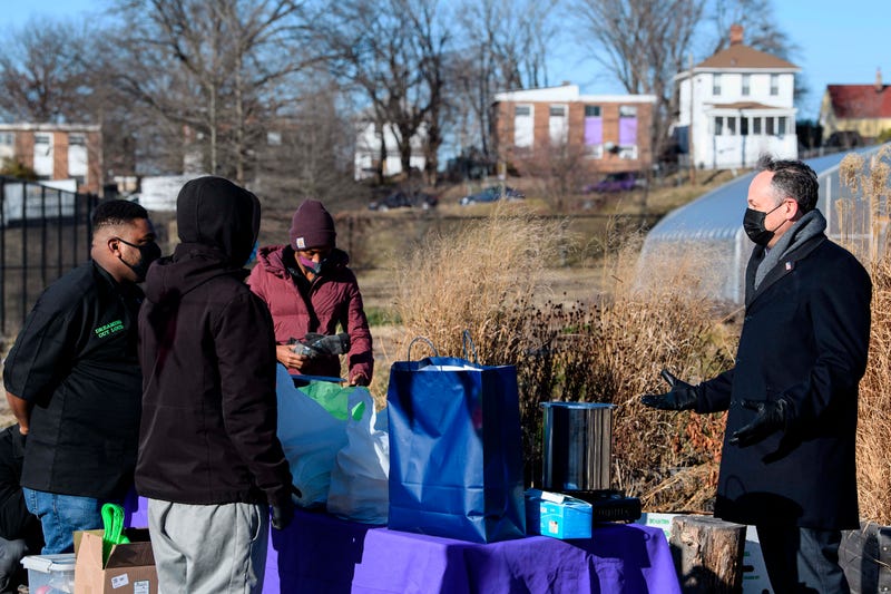Second gentleman Doug Emhoff, the spouse of Vice President Kamala Harris, speaks with volunteers of Dreaming out Loud, a nonprofit organization focused on food security and economic opportunity, during a visit to Kelly Miller Middle School in Washington, Thursday, Jan. 28, 2021.