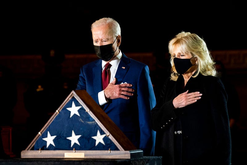 President Joe Biden and first lady Jill Biden pay their respects to the late U.S. Capitol Police officer Brian Sicknick as an urn with his cremated remains lies in honor on a black-draped table at the center of Capitol Rotunda, Tuesday, Feb. 2, 2021, in Washington. (Erin Schaff/The New York Times via AP, Pool)
