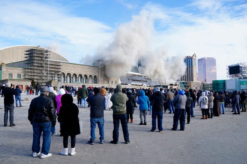 People observe the demolition of Trump Plaza casino from the beach at Atlantic City, N.J., on February 17, 2021.