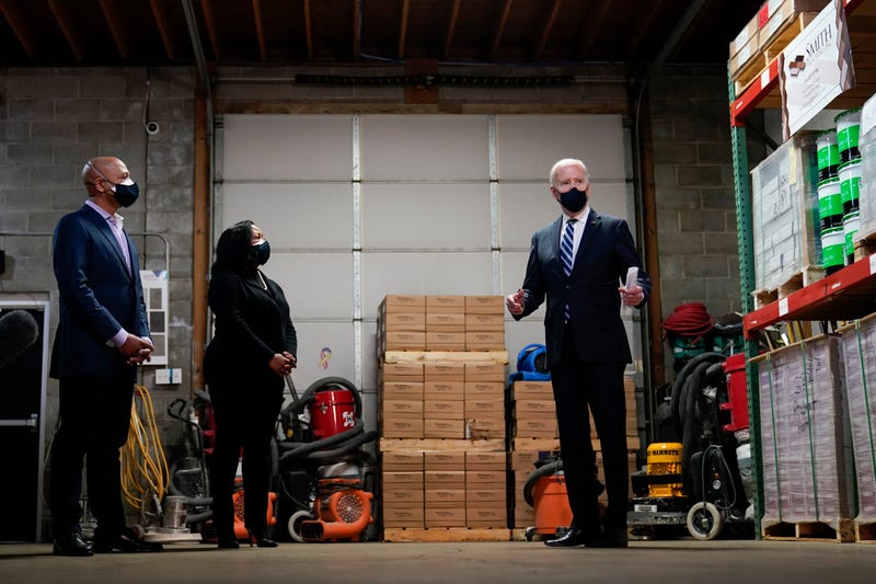 President Joe Biden speaks with owners Kristin Smith and James Smith as he visits Smith Flooring in Chester, Pa., Tuesday, March 16, 2021.