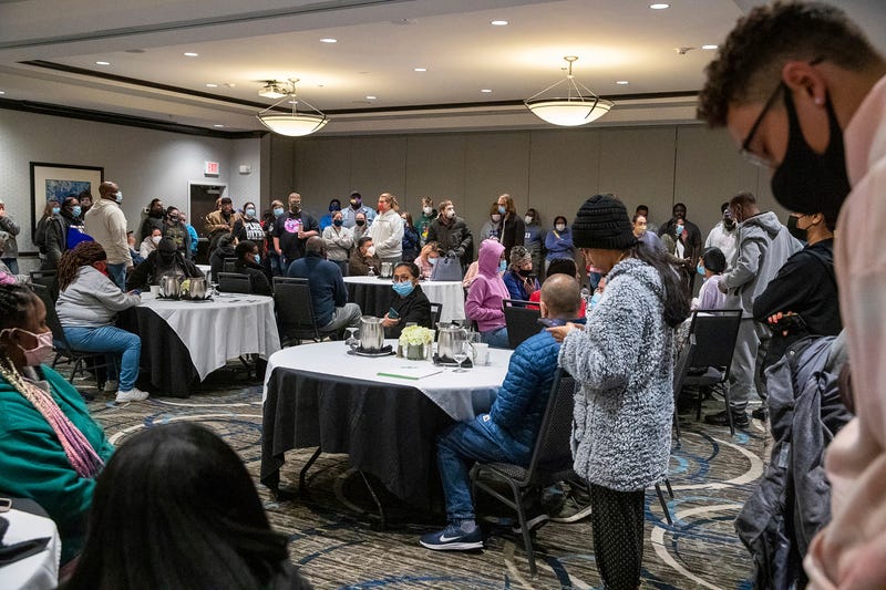 Family and friends wait for word of their loved ones who were at the FedEx Ground facility during a shooting in Indianapolis, Thursday night, April 15, 2021