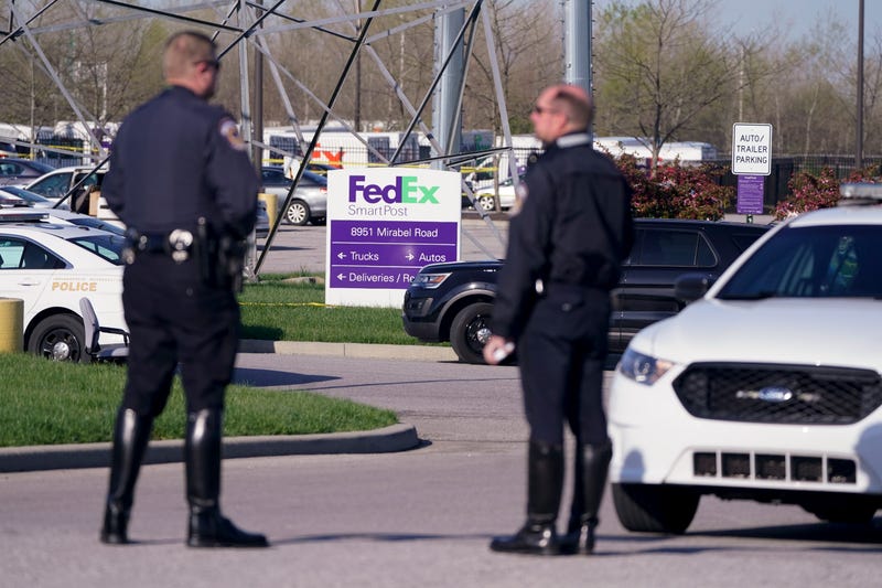 Police stand near the scene where multiple people were shot at the FedEx Ground facility early Friday morning, April 16, 2021, in Indianapolis