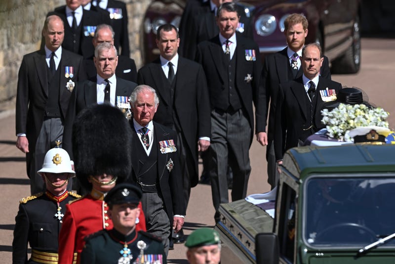 From front left, Britain's Prince Charles, Prince Andrew. Prince Edward, Prince William, Peter Phillips, Prince Harry, Earl of Snowdon and Tim Laurence follow the coffin the coffin makes it's way past the Round Tower during the funeral of Britain's Prince Philip inside Windsor Castle in Windsor, England Saturday April 17, 2021. 