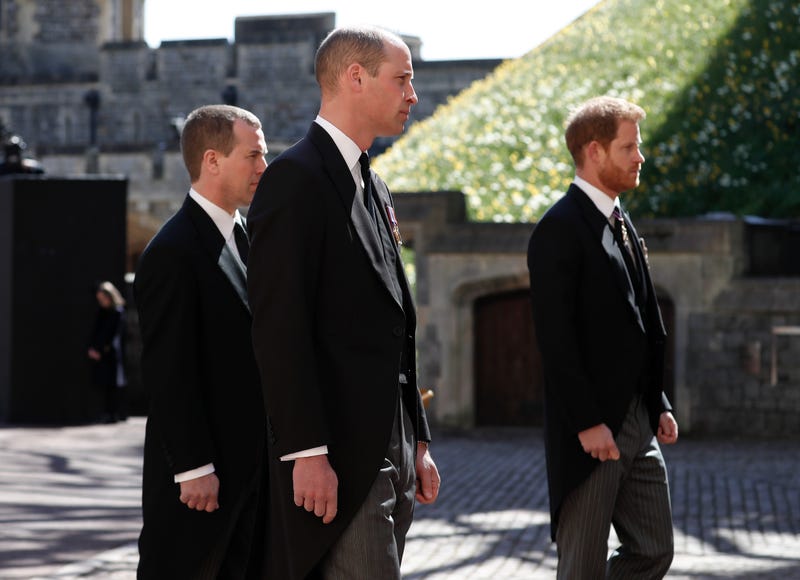 Britain's Prince Harry, right, Prince William, Peter Phillips, left, follow the coffin in a ceremonial procession for the funeral of Britain's Prince Philip inside Windsor Castle in Windsor, England Saturday April 17, 2021.