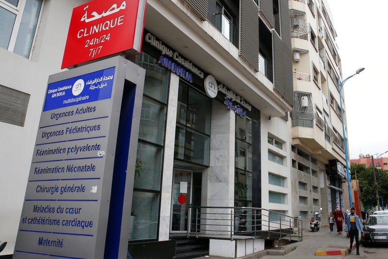 A man stands in front of the Ain Borja private clinic in Casablanca, Morocco, Wednesday, May 5, 2021. A Malian woman has given birth to nine babies after only expecting seven, Mali's Ministry of Health said Wednesday. The 25-year-old Halima Cisse gave birth to the babies via Caesarean section on Tuesday in Morocco after being sent there for special care, the ministry announced.
