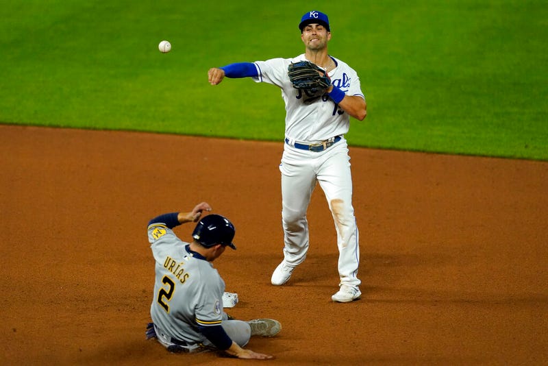 Kansas City Royals second baseman Whit Merrifield throws to first for the double play
