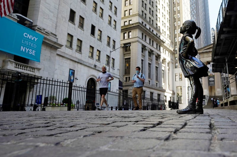 The "Fearless Girl" statue faces the New York Stock Exchange, Wednesday, June 16, 2021. Stocks are opening broadly higher on Wall Street Friday, June 25 keeping the S&P 500 on track for its biggest weekly gain since April. (AP Photo/Richard Drew)