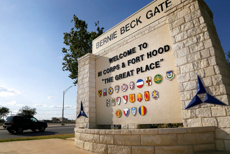 Traffic flows through the main gate past a welcome sign in Fort Hood, Texas.