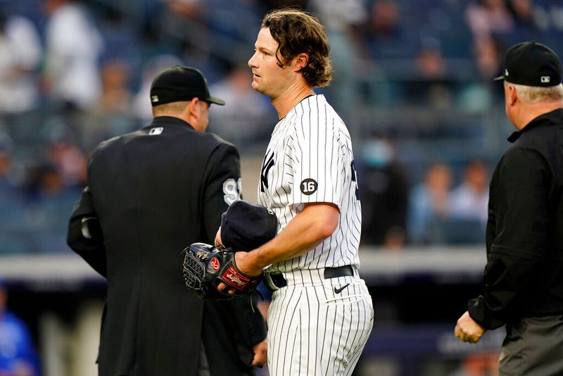 New York Yankees starting pitcher Gerrit Cole reacts after umpire Bill Miller, right, checked him for foreign substances.