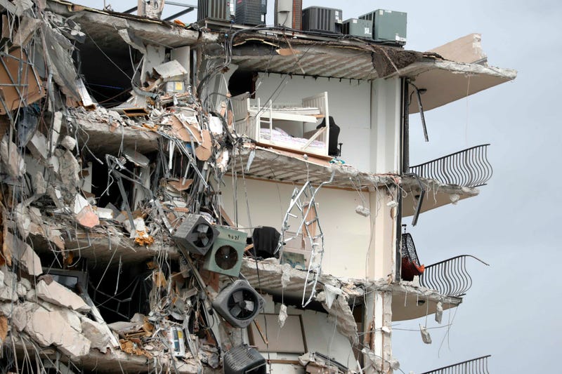 Items and debris dangle from a section of the oceanfront Champlain Towers South Condo that partially collapsed Thursday, June 24, 2021, in the Surfside area of Miami, Fla