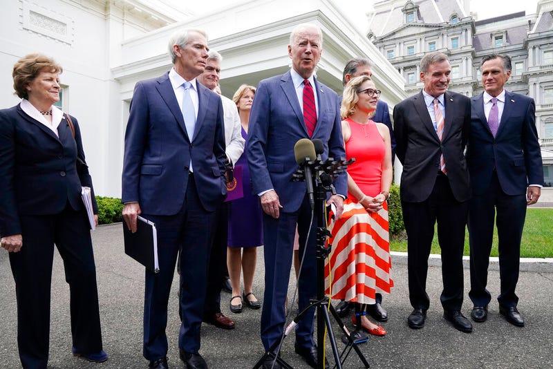 President Joe Biden, with a bipartisan group of senators, speaks Thursday June 24, 2021, outside the White House in Washington. Biden invited members of the group of 21 Republican and Democratic senators to discuss the infrastructure plan. From left are, Sen. Jeanne Shaheen, D-N.H., Sen. Rob Portman, R-Ohio, Sen. Bill Cassidy, R-La., Sen. Lisa Murkowski, R-Alaska, Biden, Sen, Joe Manchin, D-W.Va., rear, Sen. Kyrsten Sinema, D-Ariz, Sen. Mark Warner, D-Va., and Sen. Mitt Romney, R-Utah. 
