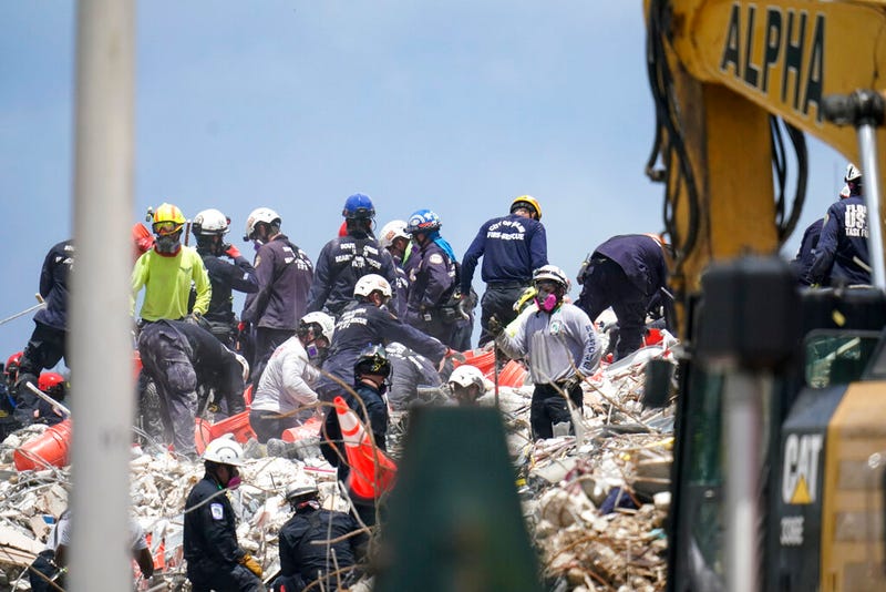 Workers search the rubble at the Champlain Towers South condo, Monday, June 28, 2021, in Surfside, Fla. Many people were still unaccounted for after Thursday's fatal collapse. (AP Photo/Gerald Herbert)