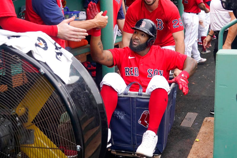 Boston Red Sox's Danny Santana celebrates his three-run homer against the Kansas City Royals with a dugout ride in a laundry cart.