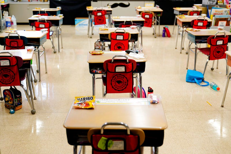 In this Thursday, March 11, 2021 file photo, desks are arranged in a classroom at an elementary school in Nesquehoning, Pa. In the fall of 2021, vaccinated teachers and students should no longer wear masks inside school buildings and no one need bother with them outside, the Centers for Disease Control and Prevention said Friday, July 9, 2021, in relaxing its COVID-19 guidelines.