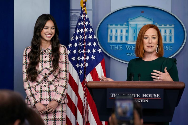 White House press secretary Jen Psaki, right, speaks about teen pop star Olivia Rodrigo, left, during the daily briefing at the White House in Washington, Wednesday, July 14, 2021. Rodrigo is at the White House to film a video to promote vaccines.