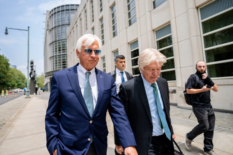 FILE - In this Monday, July 12, 2021 file photo, Horse trainer Bob Baffert, left, leaves federal court in the Brooklyn borough of New York. A New York federal judge on Wednesday, July 14, 2021 nullified the suspension of horse trainer Bob Baffert, finding that the New York Racing Association acted unconstitutionally by failing to let him adequately respond to claims made against him after Kentucky Derby winner Medina Spirit failed a postrace drug test.(AP Photo/John Minchillo, File)