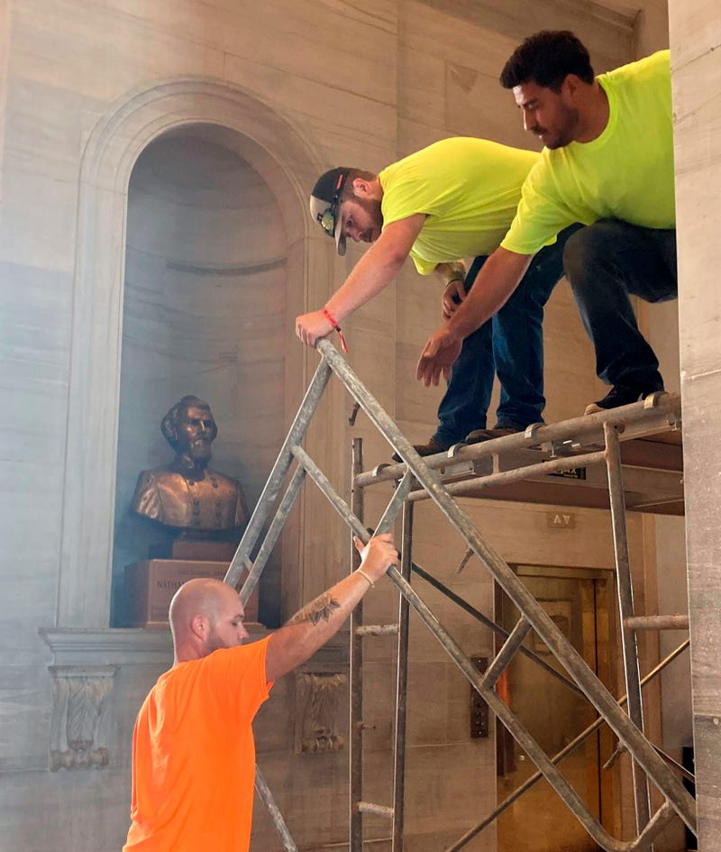 Workers prepare scaffolding in front of a bust of Confederate general and early Ku Klux Klan leader Nathan Bedford Forrest at the State Capitol Thursday, July 22, 2021, in Nashville, Tenn. A decadeslong effort to remove the bust from the Tennessee Capitol cleared its final hurdle Thursday, with state leaders approving the final vote needed to allow the statue to be relocated to a museum.
