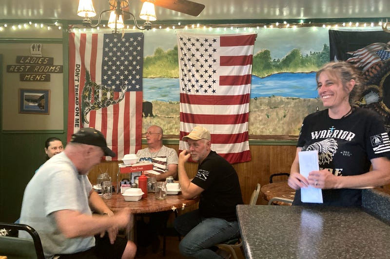 Pauline Bauer, right, speaks with customers at her restaurant, Bob’s Trading Post