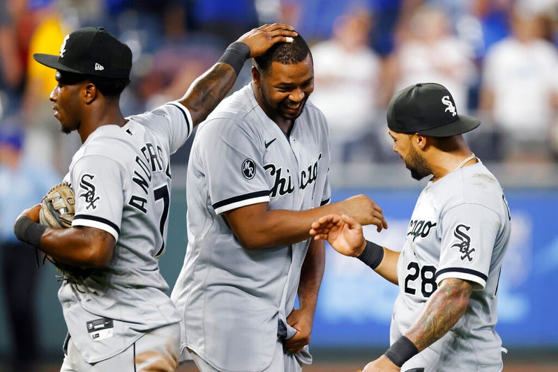 Chicago White Sox's Eloy Jimenez, center, celebrates with Tim Anderson (7) and Leury Garcia (28) at the end of the game