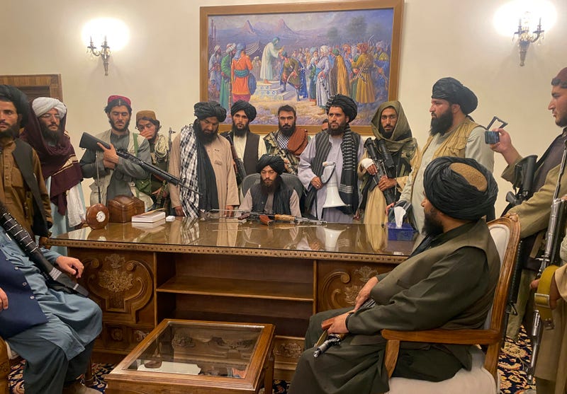 Taliban fighters take control of the Afghan presidential palace after the Afghan President Ashraf Ghani fled the country, in Kabul, Afghanistan, Sunday, Aug. 15, 2021.
