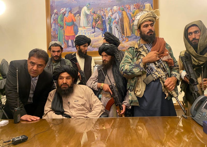 Taliban fighters take control of the Afghan presidential palace after the Afghan President Ashraf Ghani fled the country, in Kabul, Afghanistan, Sunday, Aug. 15, 2021.