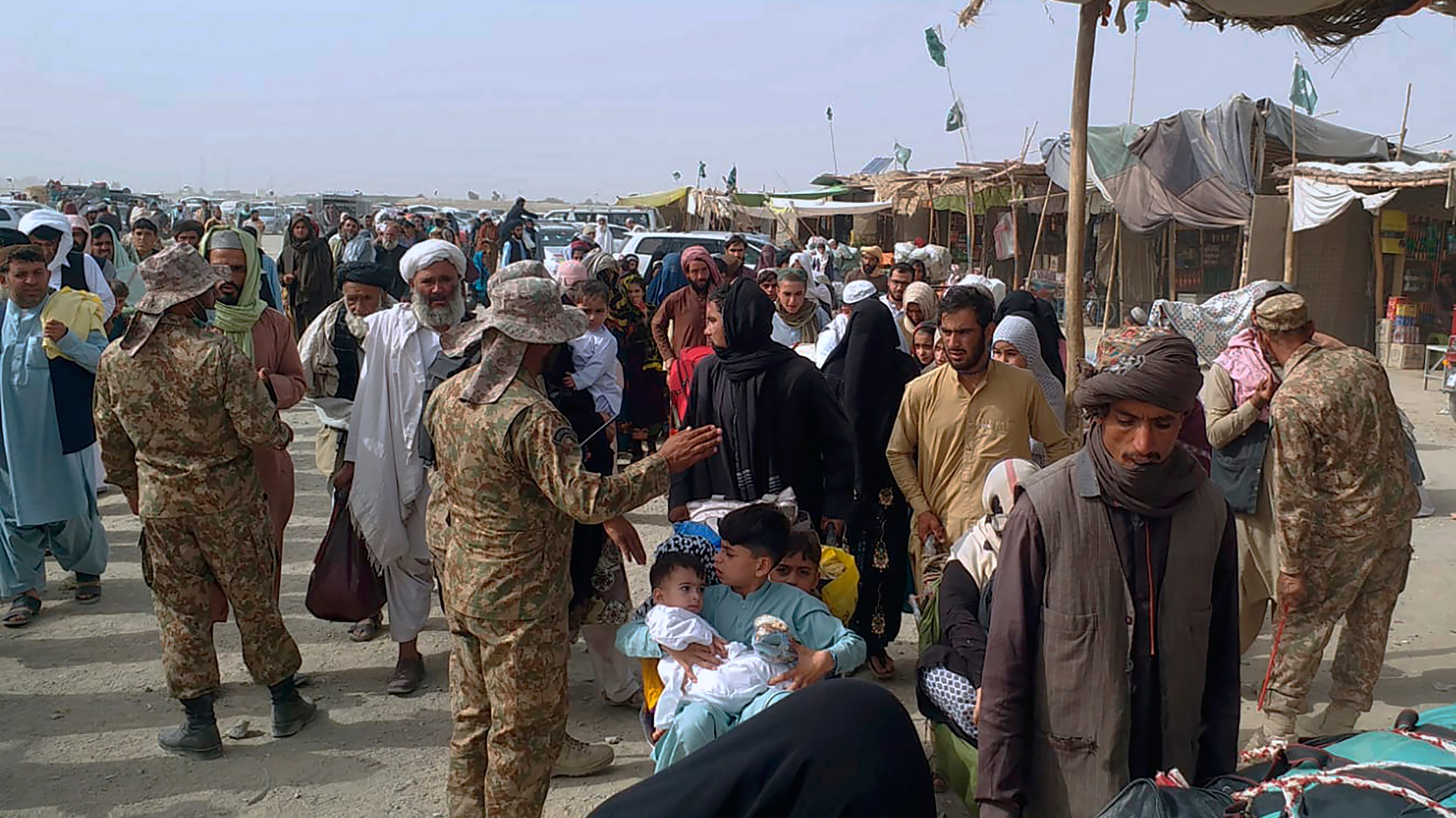 Afghans attempt to flee through Kabul airport as Taliban sweeps through capital