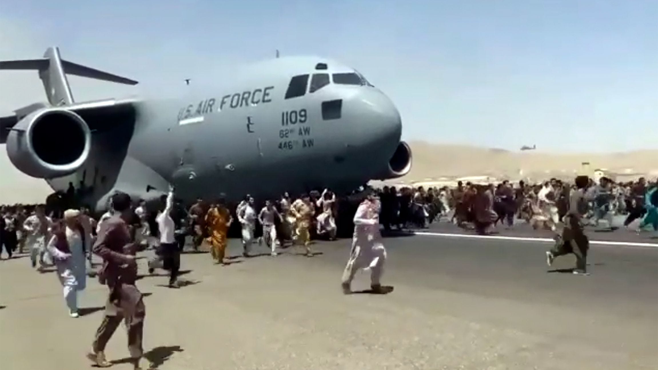 Video: Desperate Afghans climbing U.S. Air Force jet trying to escape