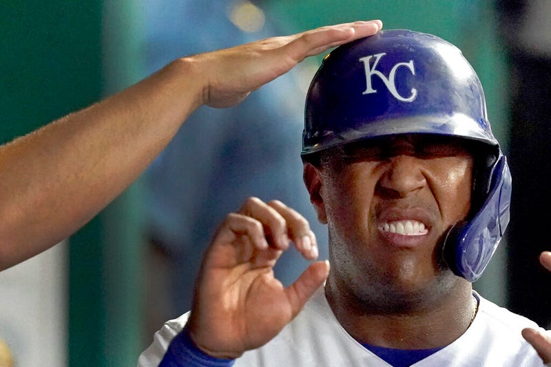 Kansas City Royals' Salvador Perez celebrates in the dugout after scoring on a single by Ryan O'Hearn