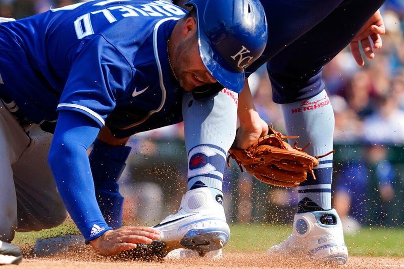 Kansas City Royals' Whit Merrifield, left, steals third base against Chicago Cubs third baseman Patrick Wisdom in the eighth inning of a baseball game Friday, Aug. 20, 2021, in Chicago. (AP Photo/Nam Y. Huh)