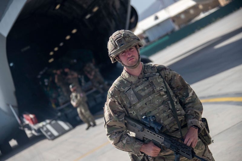 Photo issued on Saturday Aug. 28, 2021 by Britain's Ministry of Defence (MoD) showing UK military personnel boarding a A400M aircraft departing Kabul, Afghanistan. Britain ended its evacuation flights Saturday, though Prime Minister Boris Johnson promised to “shift heaven and earth” to get more of those at risk from the Taliban to Britain by other means. Britain’s ambassador to Afghanistan, Laurie Bristow, said in a video from Kabul airport and posted on Twitter that it was “time to close this phase of the operation now.” (Jonathan Gifford/MoD via AP)