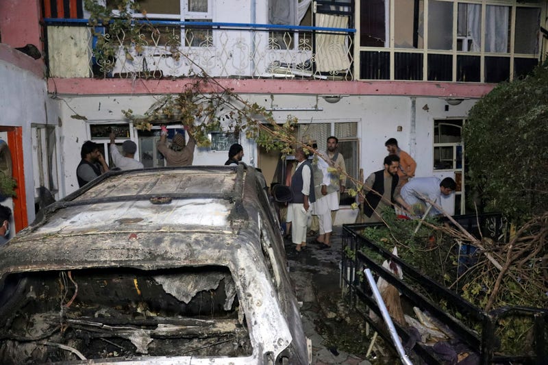 Afghan people are seen inside a house after U.S. drone strike in Kabul, Afghanistan, Sunday, Aug. 29, 2021. A U.S. drone strike destroyed a vehicle carrying "multiple suicide bombers" from Afghanistan's Islamic State affiliate on Sunday before they could attack the ongoing military evacuation at Kabul's international airport, American officials said.