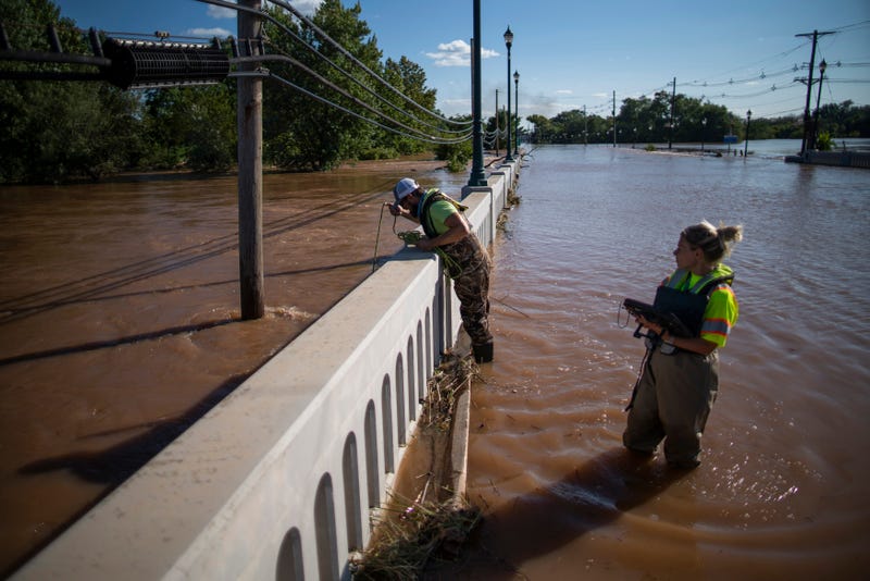 United States Geological Survey workers measure the floodwaters along the Raritan River in Somerville, N.J