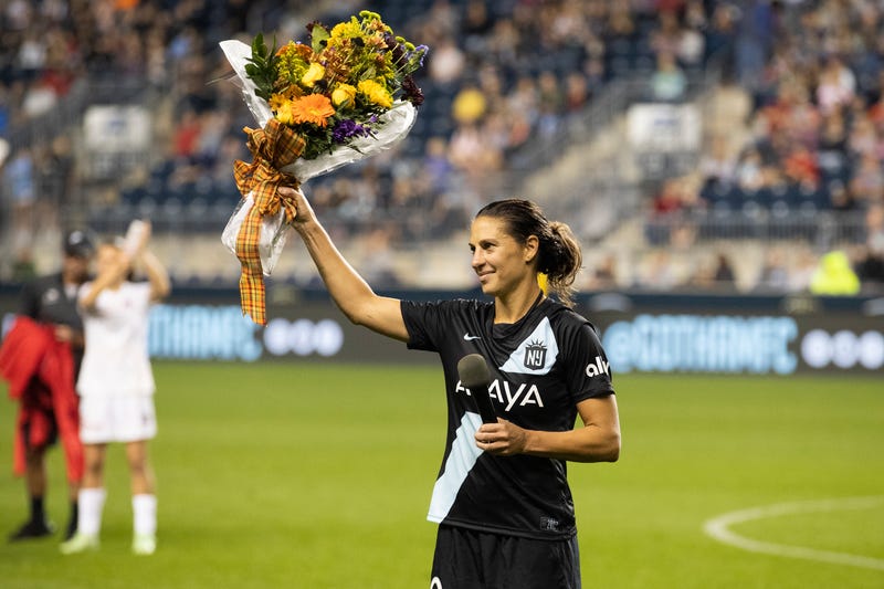 Carli Lloyd holds up a bouquet after the team's NWSL soccer match against the Washington Spirits on Wednesday, Oct. 6, 2021, in Chester, Pa.