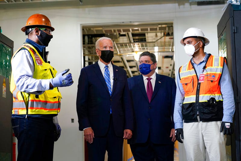 President Joe Biden tours a Clayco Corporation construction site for a Microsoft data center in Elk Grove Village, Ill., Thursday, Oct. 7, 2021, with Otto Nichols, left, and Anuraj Jhajj and Illinois Gov. J.B. Pritzker.