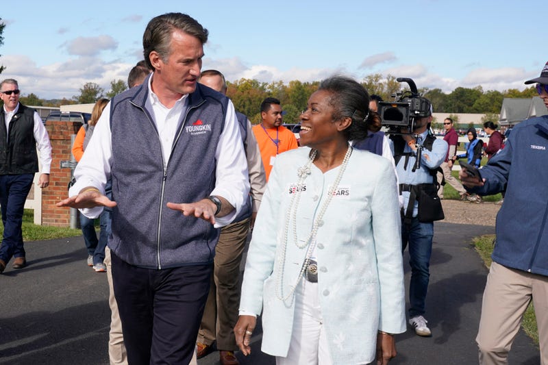 Republican gubernatorial candidate Glenn Youngkin speaks with Lt. Gov. candidate Winsome Sears after a rally in Fredericksburg, Va., Saturday, Oct. 30, 2021. Youngkin will face Democrat former Gov. Terry McAuliffe in the November election.