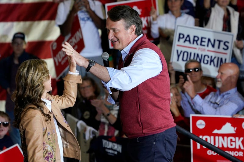 Republican gubernatorial candidate Glenn Youngkin, right, gives his wife Suzanne, a high five during a rally in Chesterfield, Va., Monday, Nov. 1, 2021. Youngkin will face Democrat former Gov. Terry McAuliffe in the November election.