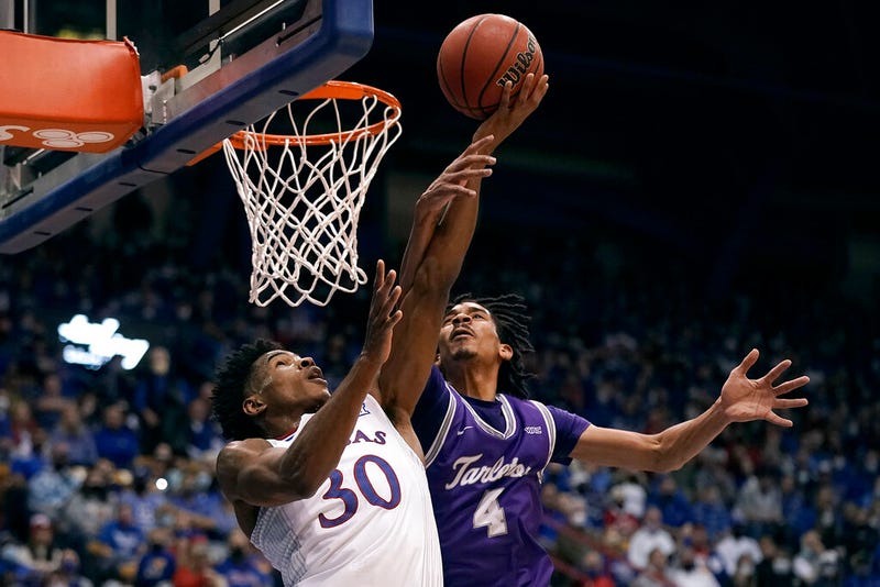 Kansas' Ochai Agbaji (30) shoots under pressure from Tarleton State's Tahj Small (4)